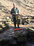 Sweeping off the stone patio at the Spring House on our property.